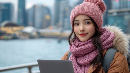 Young Woman Using Laptop in City