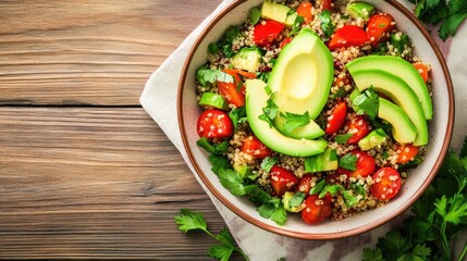 A vibrant bowl of quinoa salad topped with fresh avocado, tomatoes, and herbs, perfect for a healthy meal.