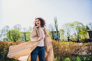 Wall Mural - Photo of pretty nice positive girl wearing trendy beige trench traveling new city park promenade spring weather outdoors