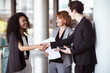 © DG PhotoStock - Group of businesspeople taking together inside the building.