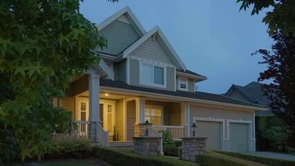 Wall Mural - Establishing shot of two story stucco luxury house with garage door, big tree and nice landscape at night in Vancouver, Canada, North America. Night time on June 2024. ProRes 422 HQ.