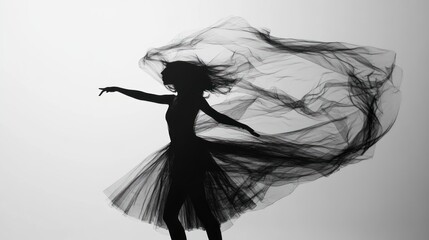 A woman in a black tulle dress dances with her arms outstretched, the fabric flowing around her like a cloud.