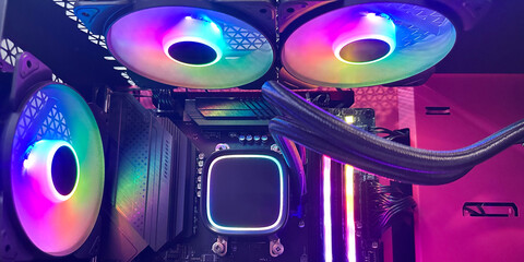 Close-up of a computer case with bright multi-colored RGB cooling system. Mobile panoramic photo, advertising banner.