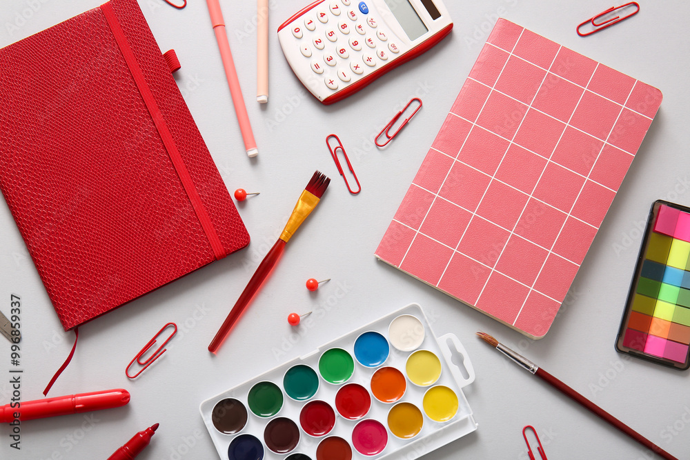 Different school stationery and notebooks on grey background