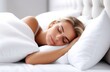 © Krystsina - Close-up. A young woman sleeps on a bed with white sheets.