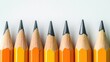 © arthit - Tapered pencils arranged in a row with plenty of empty space around them.