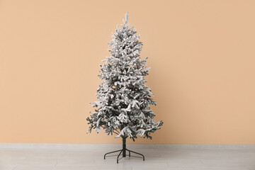 Poster - Beautiful Christmas tree near beige wall