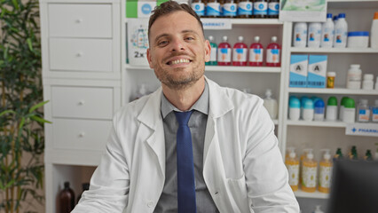 Sticker - Smiling pharmacist man in white coat at pharmacy with shelves of medication