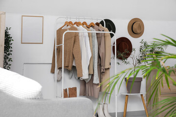 Canvas Print - Rack with stylish clothes and hanging hats in dressing room