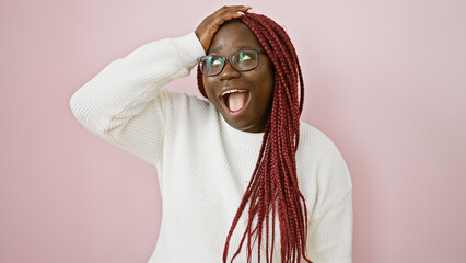 Poster - Joyful african american woman with braids wearing glasses over pink background expresses happiness.