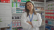 © Krakenimages.com - Confident woman pharmacist with arms crossed standing in a clean modern drugstore