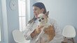 © Krakenimages.com - Hispanic woman veterinarian holding a chihuahua indoors at a veterinary clinic