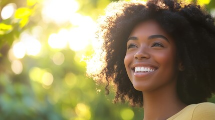 A joyful Black woman stands outside on a sunny day, smiling brightly as she enjoys the warmth and beauty of nature around her while sunlight filters through the trees