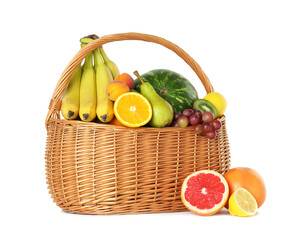 Poster - Many different fresh fruits in wicker basket isolated on white