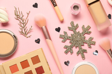 Wall Mural - Different makeup brushes, decorative cosmetics and Christmas decor on pink background, flat lay