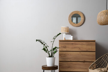 Poster - Interior of light living room with mirror, commode and plant