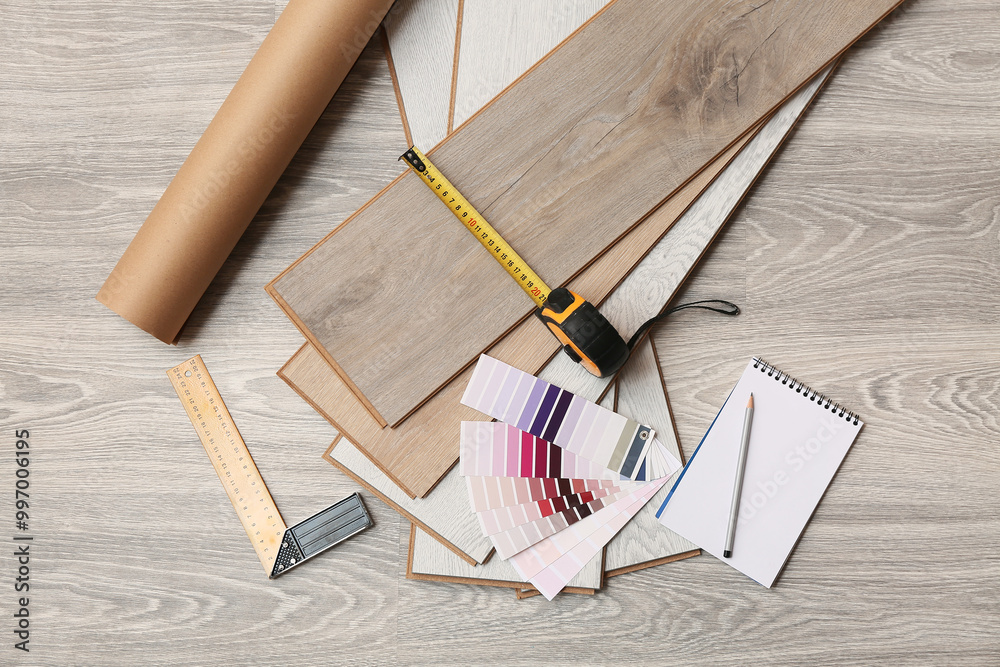 Tools, color palettes, notebook and laminate boards on floor