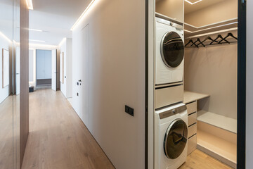 a laundry room with washer, dryer and washing machine on the wall in front of the closet door