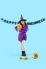 Poster - Young woman with Halloween pumpkins and garland on blue background