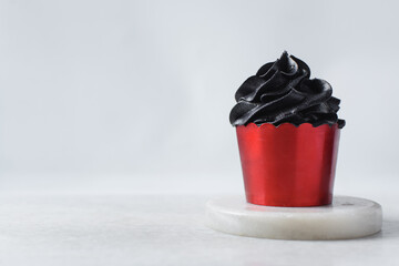 Sticker - red cupcakes with black buttercream swirl, cupcakes in red foil liners with black buttercream, frosted Halloween valentines cupcakes on a white background