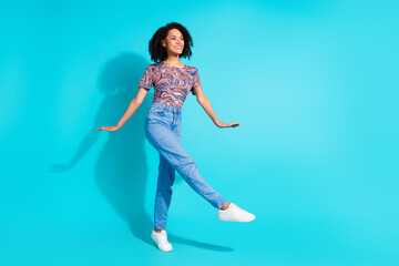 Wall Mural - Full body photo of pretty young girl cute model look empty space step wear trendy colorful clothes isolated on aquamarine color background