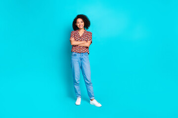 Wall Mural - Photo of attractive girl standing with crossed hands isolated cyan color background