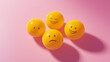 © Ice Cream Paradise - emotional, mood, excitement concept: three yellow balls with joyful, excited faces arranged in a playful, bouncy pattern against an isolated soft pink background