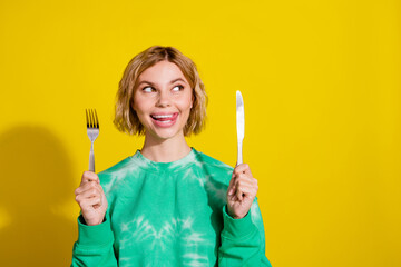 Canvas Print - Photo of adorable dreamy girl wear tie dye sweatshirt rising kitchen utencils looking empty space isolated yellow color background