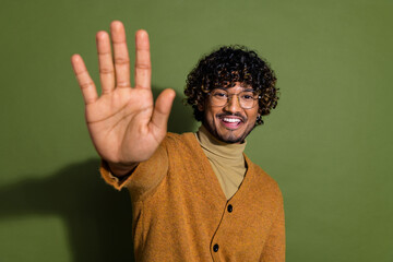 Poster - Photo portrait of pretty young male wave hand hello wear trendy brown outfit isolated on khaki color background