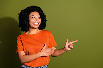 Wall Mural - Photo portrait of pretty young girl point look empty space wear trendy orange outfit isolated on khaki color background