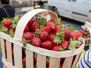 Boxes with french sweet organic red ripe strawberries Fraises, harvested in France on local farmers market