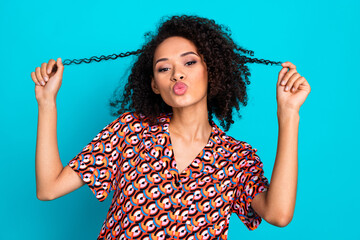 Poster - Photo of flirty attractive lady dressed print shirt holding curls sending kiss isolated turquoise color background