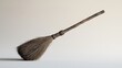© Farha - A simple wooden broom sits isolated on a clean white background, rustic and traditional.