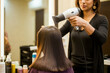 © ProArt Studios - Gorgeous indian young woman getting her hair blow dried at a salon