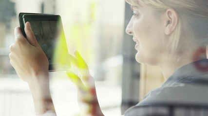Aufkleber - A young businesswoman scrolling through photos on her wireless tablet. A happy woman sitting in a cafe using her digital tablet to connect online. Young woman looking at photos on her tablet
