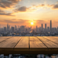 wooden table sits empty on balcony, offering stunning view of blurred city skyline at sunset. warm glow of sun casts beautiful light, creating serene atmosphere