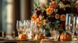 © Elmira - A beautifully arranged wedding table features lush orange and burgundy floral arrangements, polished cutlery, and charming mini pumpkins, creating a warm autumn ambiance