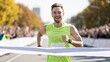 © Nitchalee N. - A joyful runner in a bright green outfit crosses the finish line, celebrating success amid a cheering crowd on a sunny day.