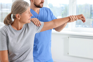 Sticker - Physiotherapist working with senior patient in rehabilitation center