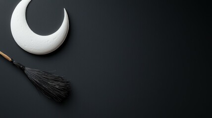 Canvas Print - A black and white image of a broom and a crescent moon