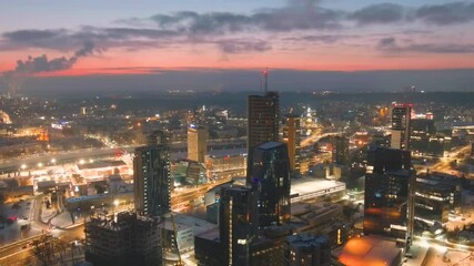 Wall Mural - Beautiful aerial night view of illuminated business district in Vilnius. Scenic winter evening downtown landscape in the capital of Lithuania.