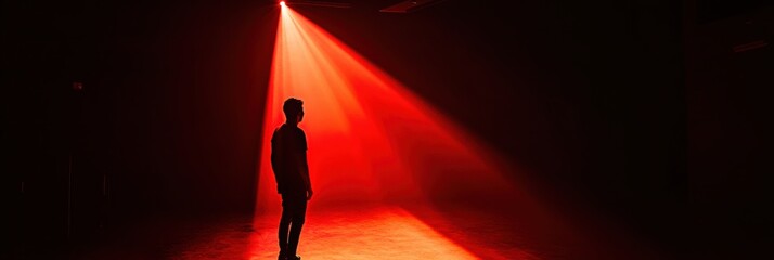 Aufkleber - In a dimly lit space, a shadowy figure is caught in a single, bright spotlight, creating an eerie atmosphere filled with suspense. Generative AI