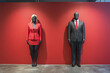© Vovmar - US presidential election concept. Women's and men's business suits against a red wall. Generative AI