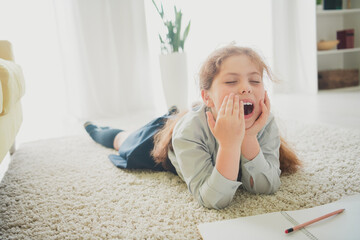 Poster - Photo of cute pretty dreamy girl learner lying carpet doing homework comfy home room interior daylight indoors