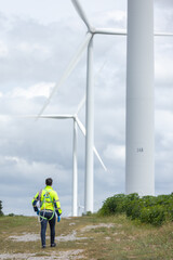 Fototapete - Man engineers holding tools box and rope to maintenance working in wind turbine. Renewable energy power wind turbine. Technology protect environment reduce global warming problems
