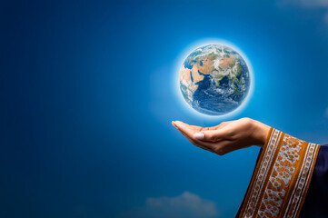 Woman hand holding planet earth on clear cloudy sky background, copy space. Woman with traditional outfit.