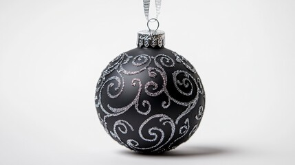 Canvas Print - Isolated black Christmas ornament with intricate silver designs, hanging from a ribbon on a white background, space for text 