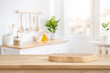 © didecs - Podium or cutting board on wooden table on defocused rustic kitchen bench interior background
