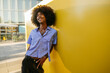© VISTA by Westend61 - Smiling gay man day dreaming near yellow wall