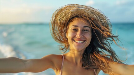 Wall Mural - A woman with long brown hair and a straw hat is smiling at the camera